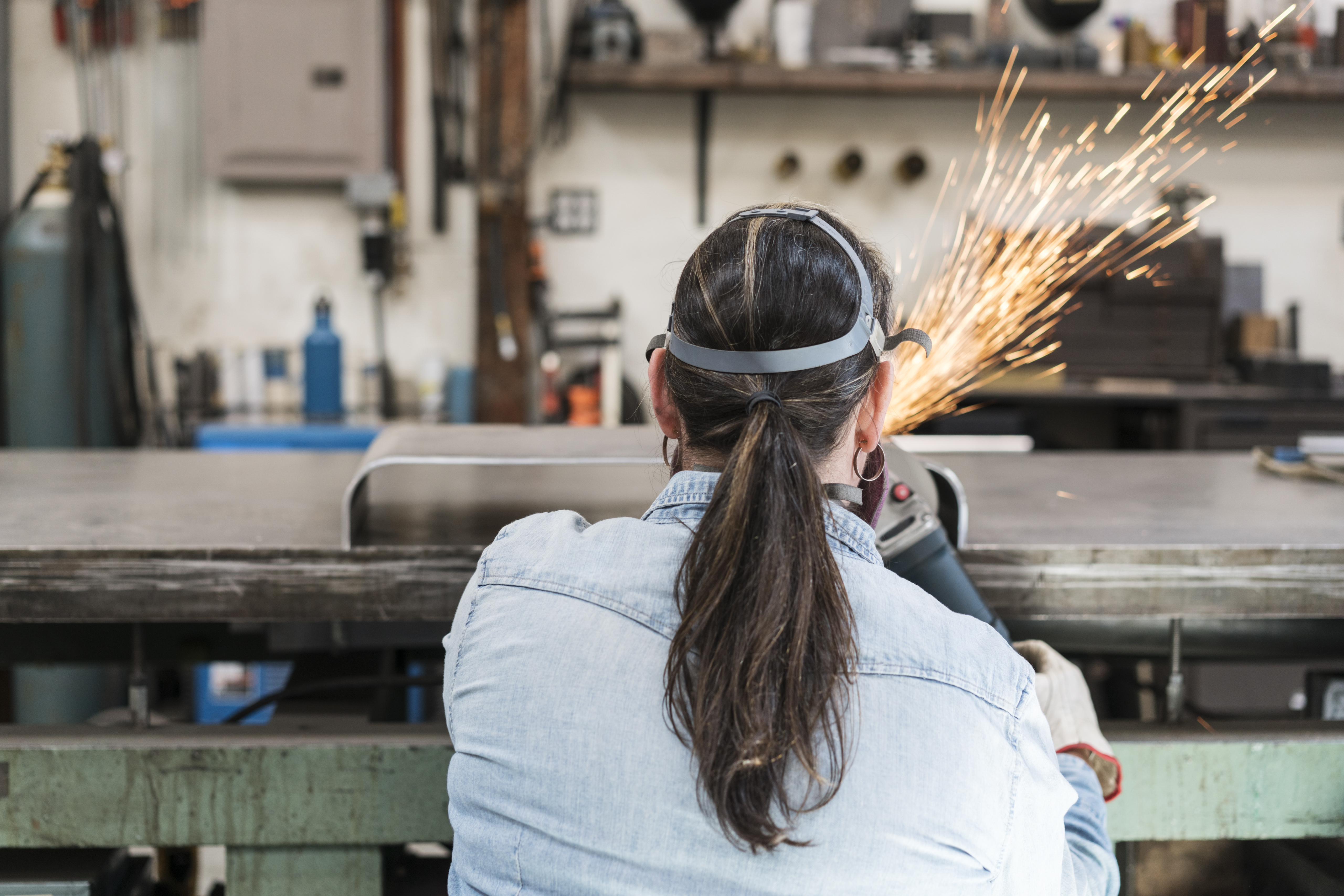 Woman working on metal